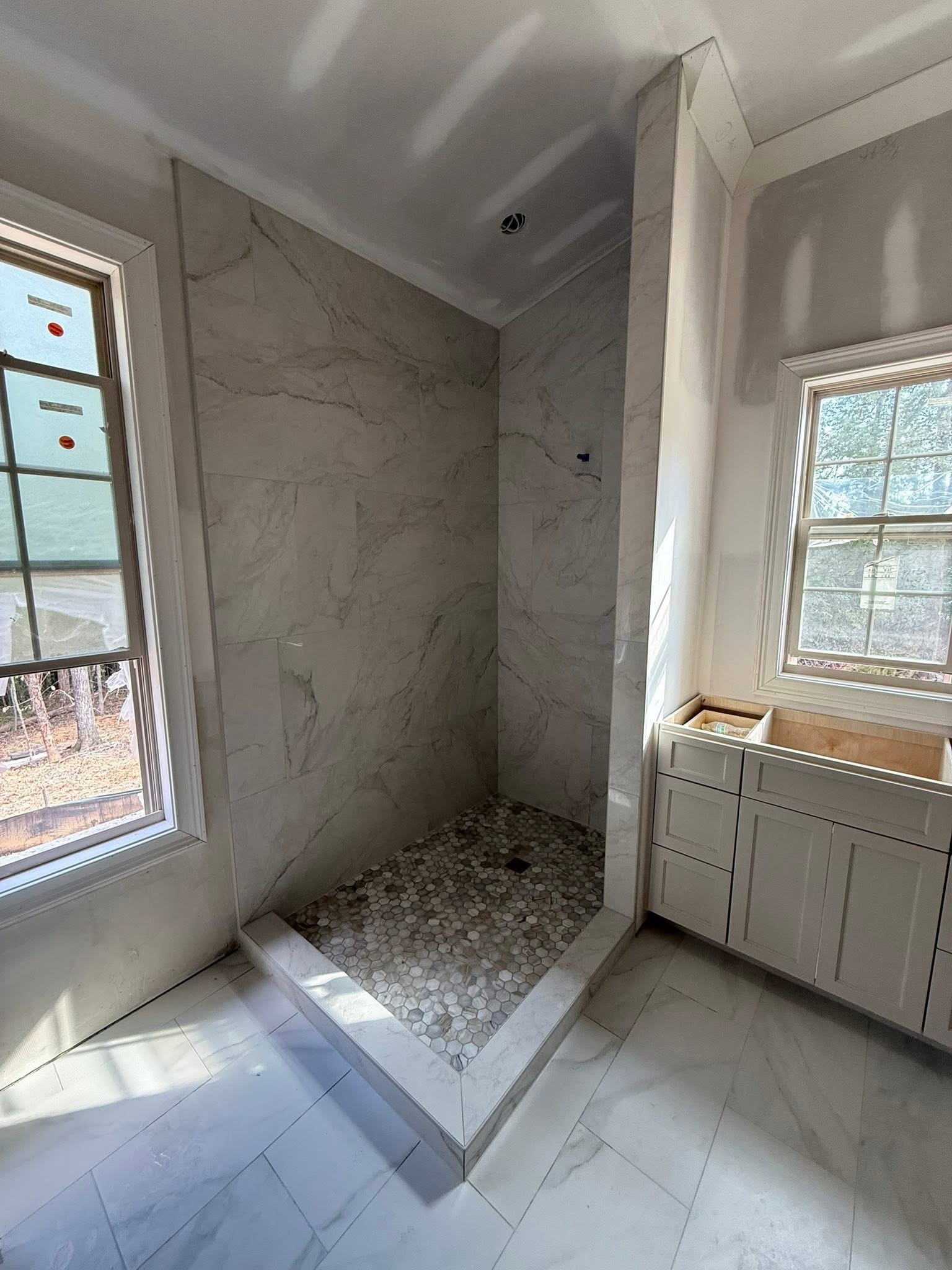 Finished bathroom with tilework and fixtures