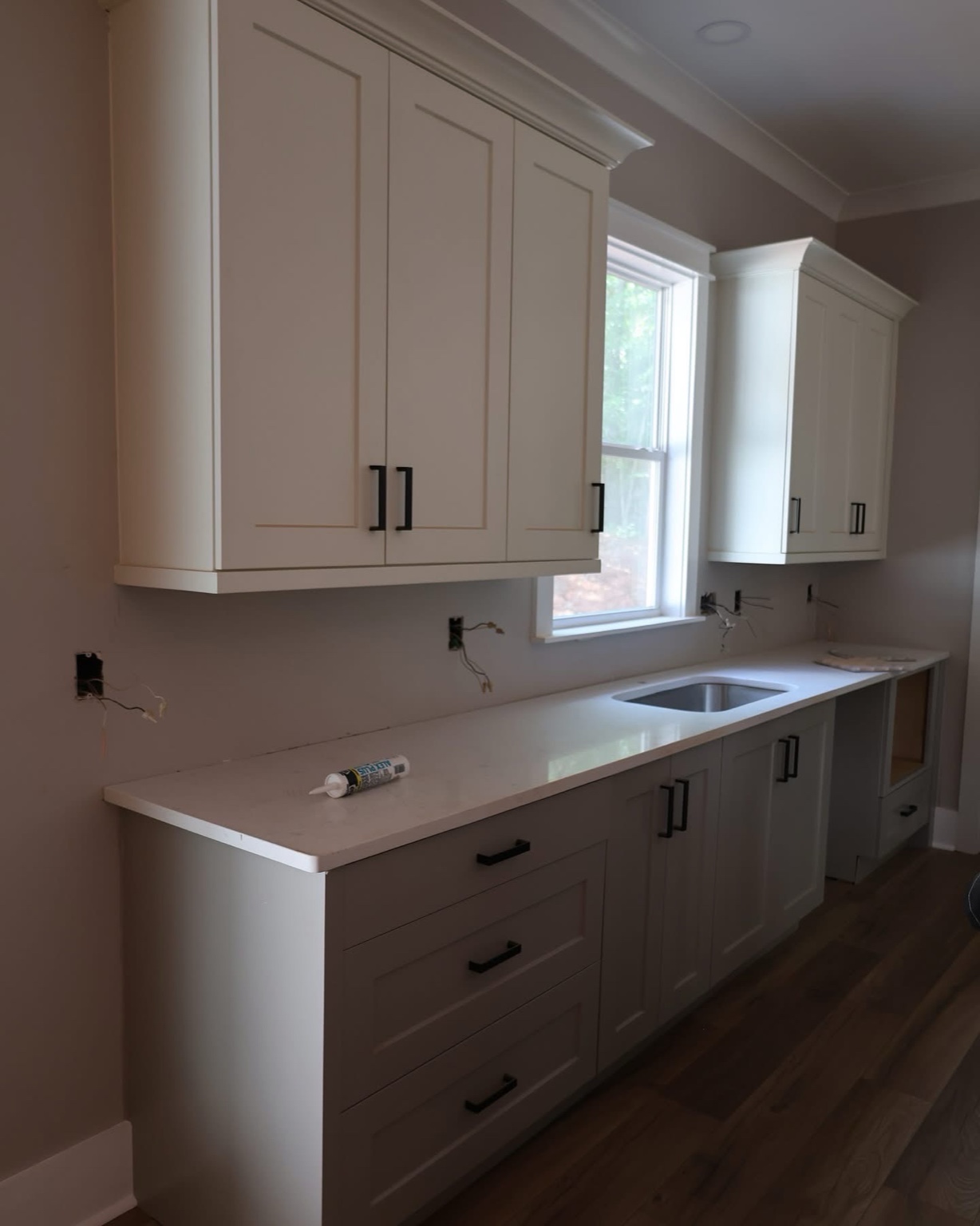 Perimeter kitchen run with white shaker cabinets and quartz top