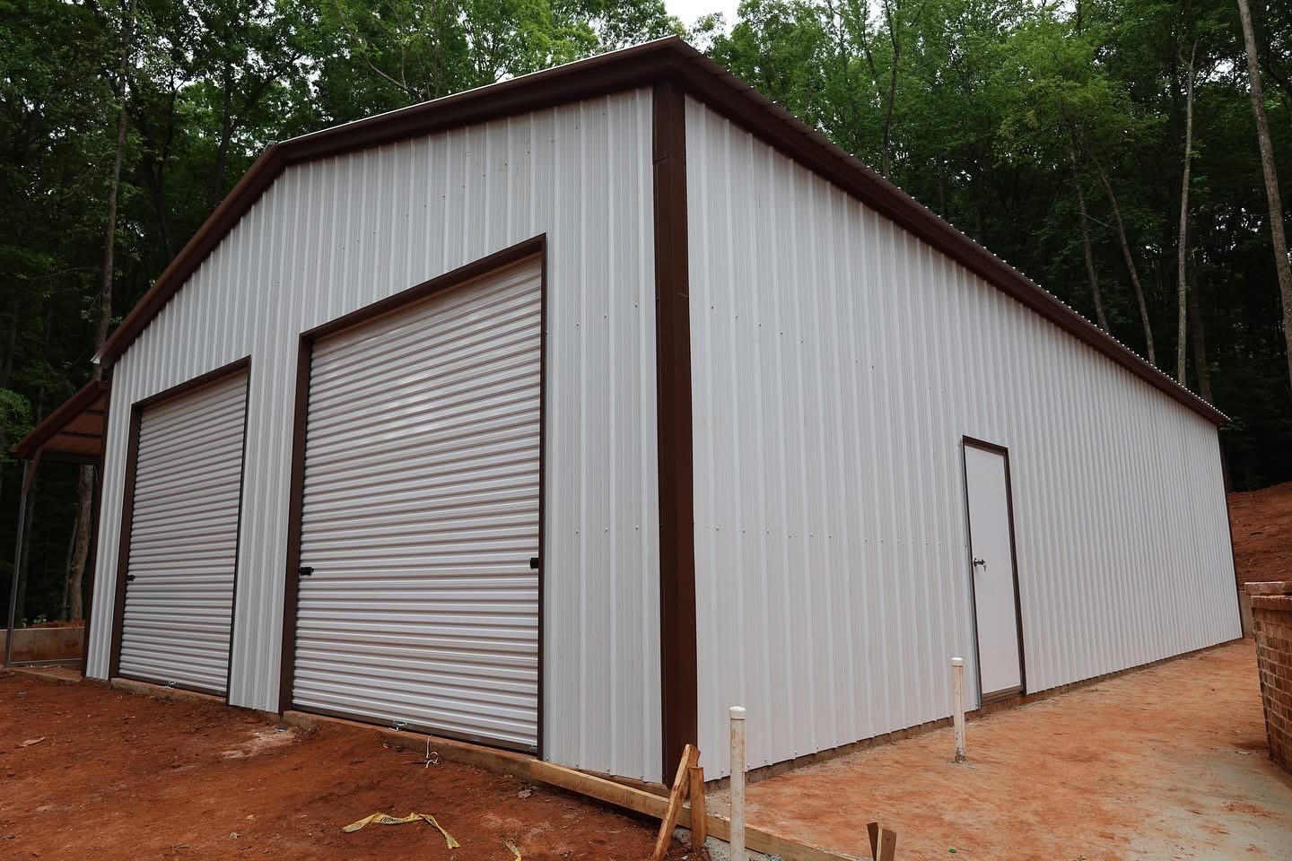 Detached steel workshop with twin roll-up doors