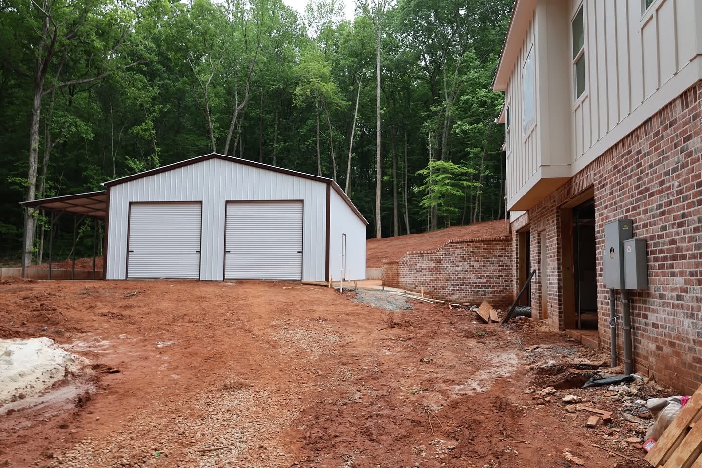 Workshop and driveway graded beside brick retaining wall and walk-out level