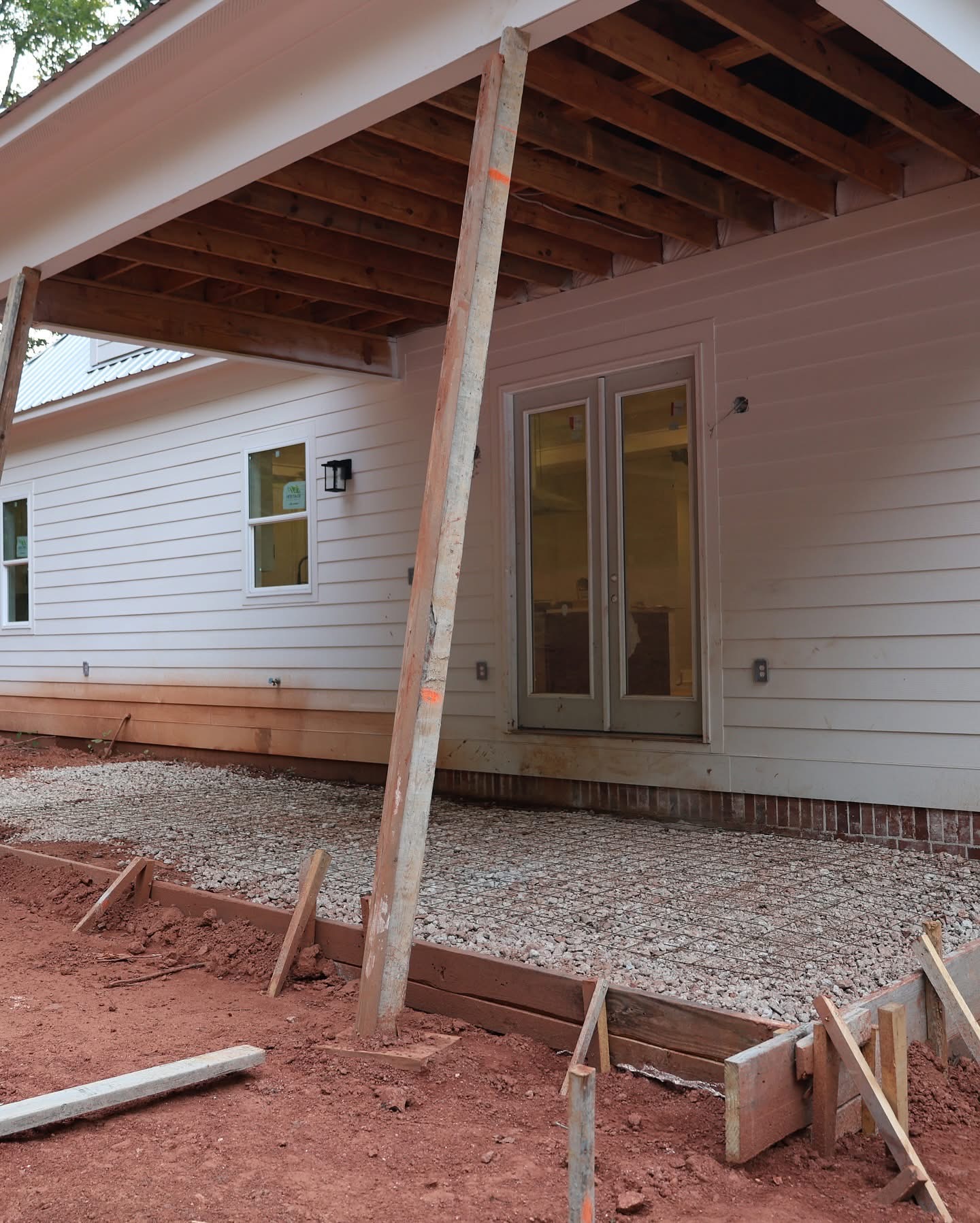 Back porch slab prep with forms and gravel base during construction